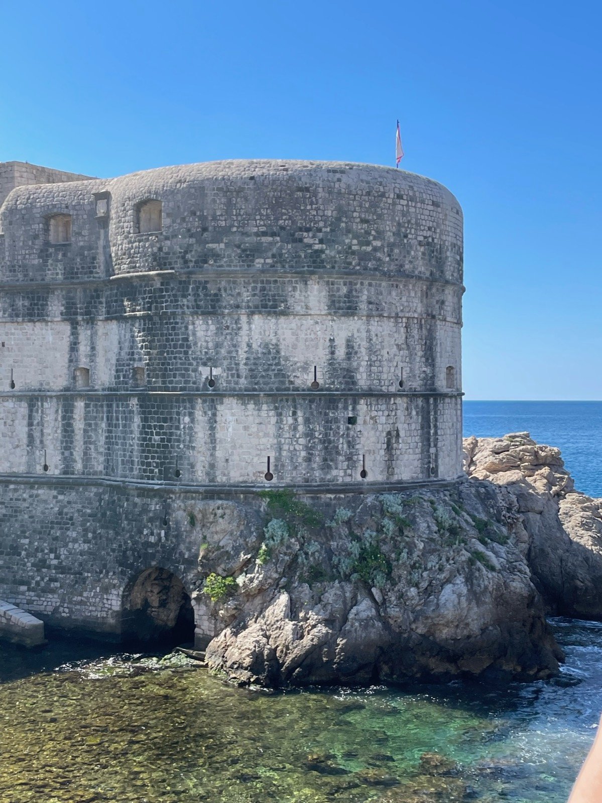 View of Dubrovnik harbor through the old city wall